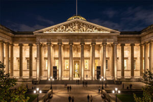 A beautifully lit museum facade at night, showcasing architectural details