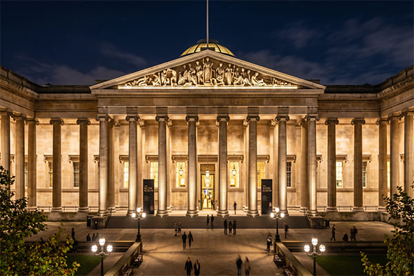 A beautifully lit museum facade at night, showcasing architectural details